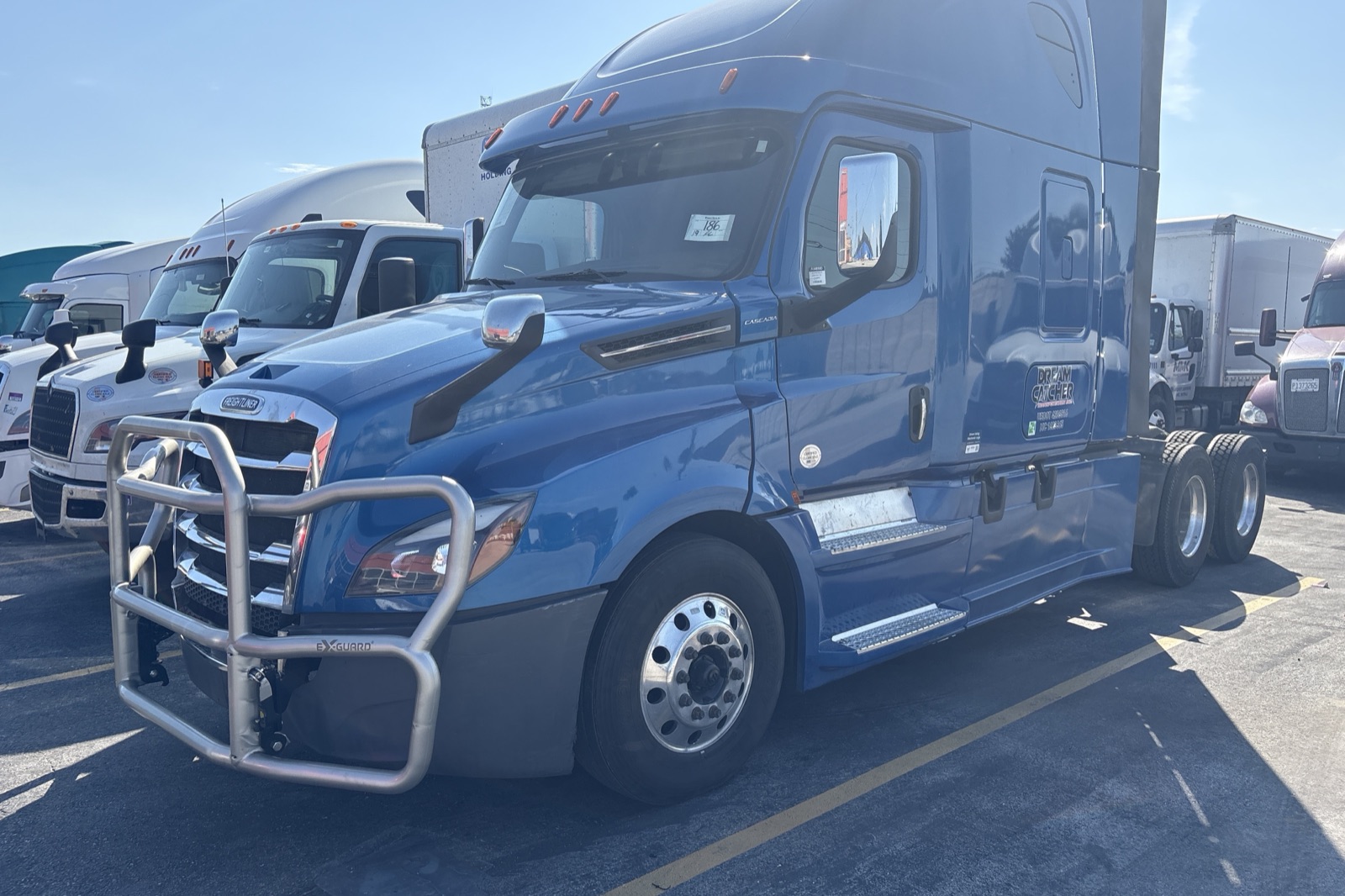 Blue Dream Catcher Transportation Freightliner Cascadia with a chrome grille guard and the Dream Catcher logo on the door